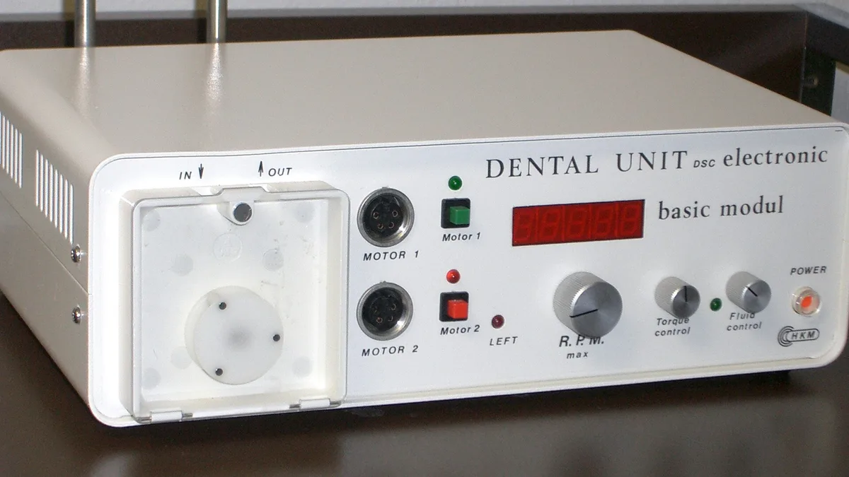 dentist holding fake set teeth