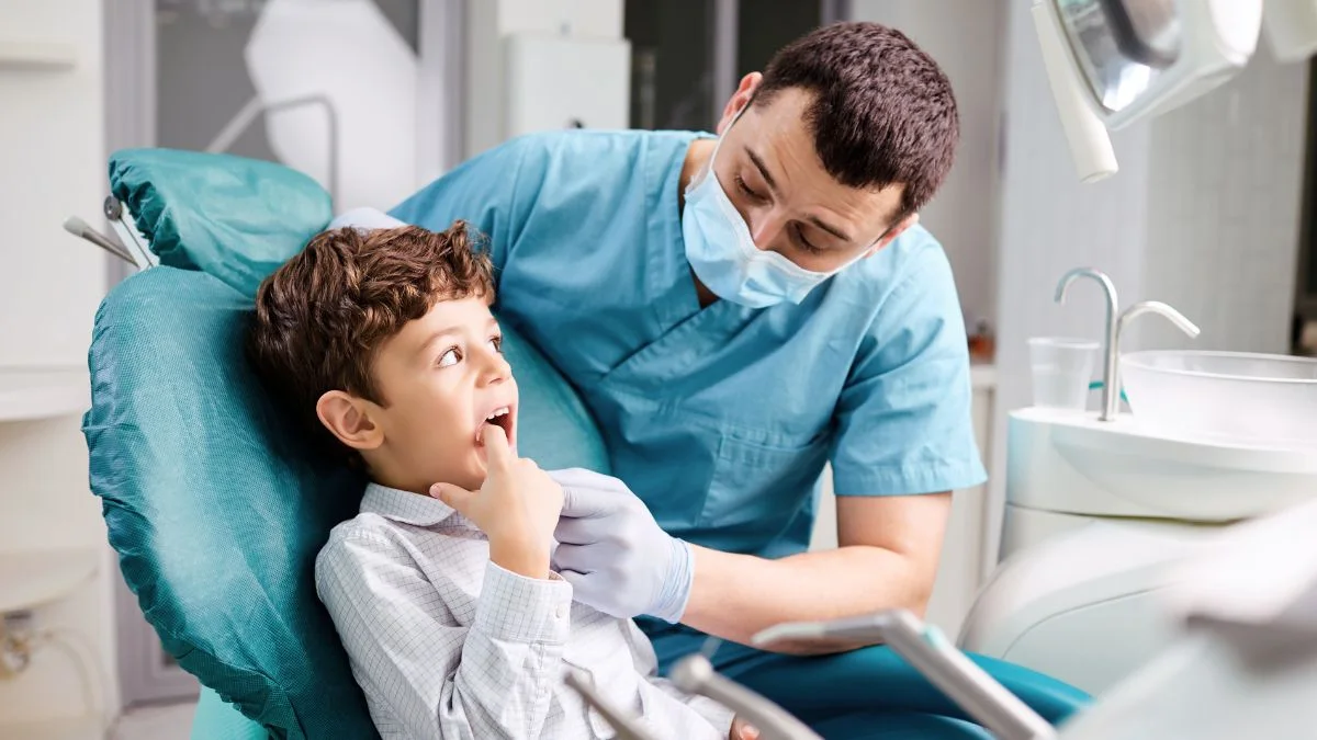 Dentista explicando a un niño en la consulta
